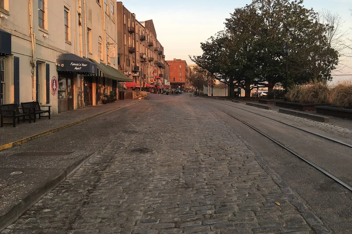 River Street at first light, with cobbles and tramlines in the foreground and shopfronts catching the low sun.